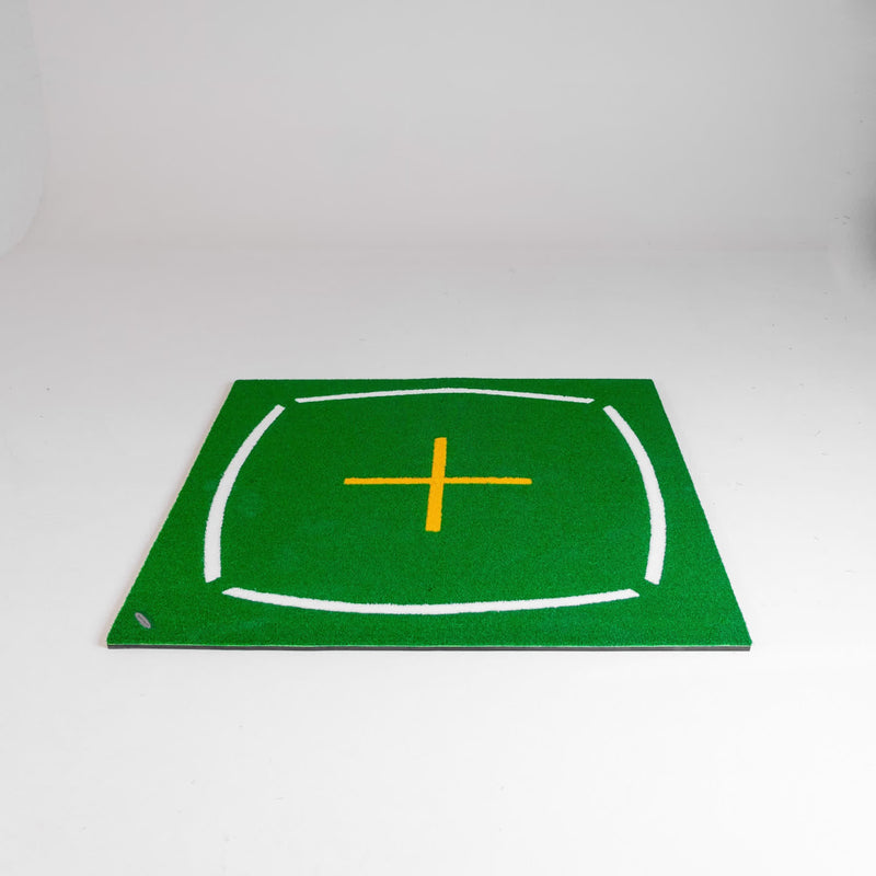 Green mat with a yellow cross on a white background